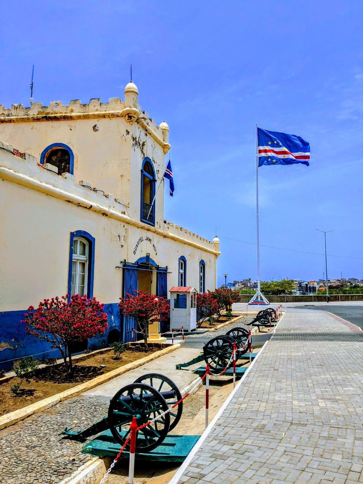 Cape Verde flag and historic cannons outside the Jaime Mota barracks in Praia